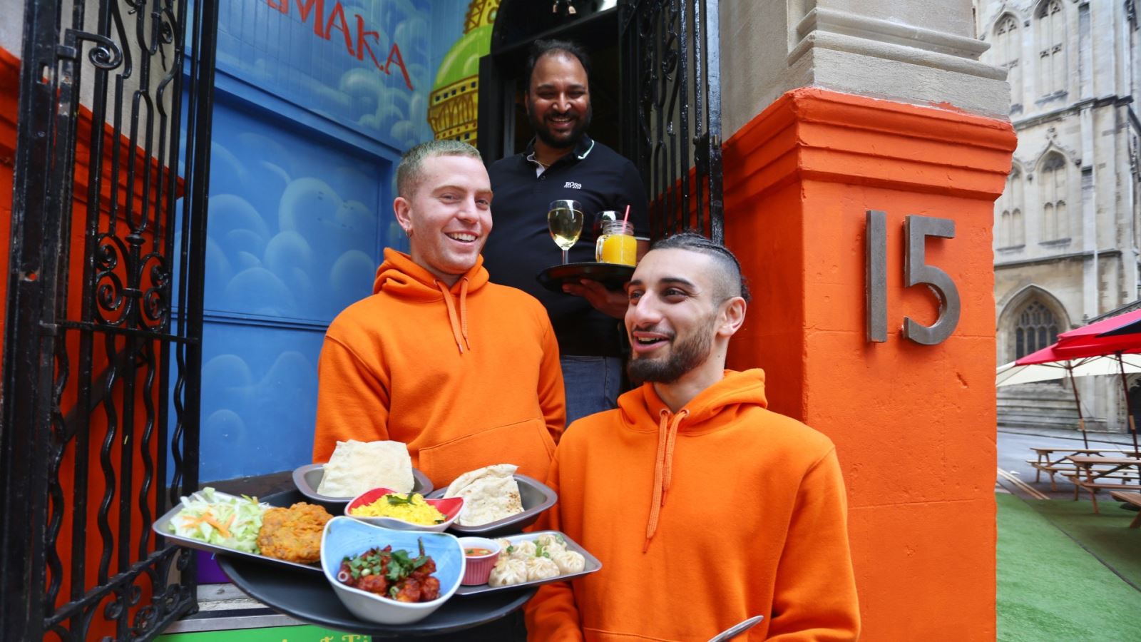 Staff smile on the steps on restaurant, Dhamaka